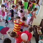 Dzieci tańczą w parach trzymając balon plecami..jpg